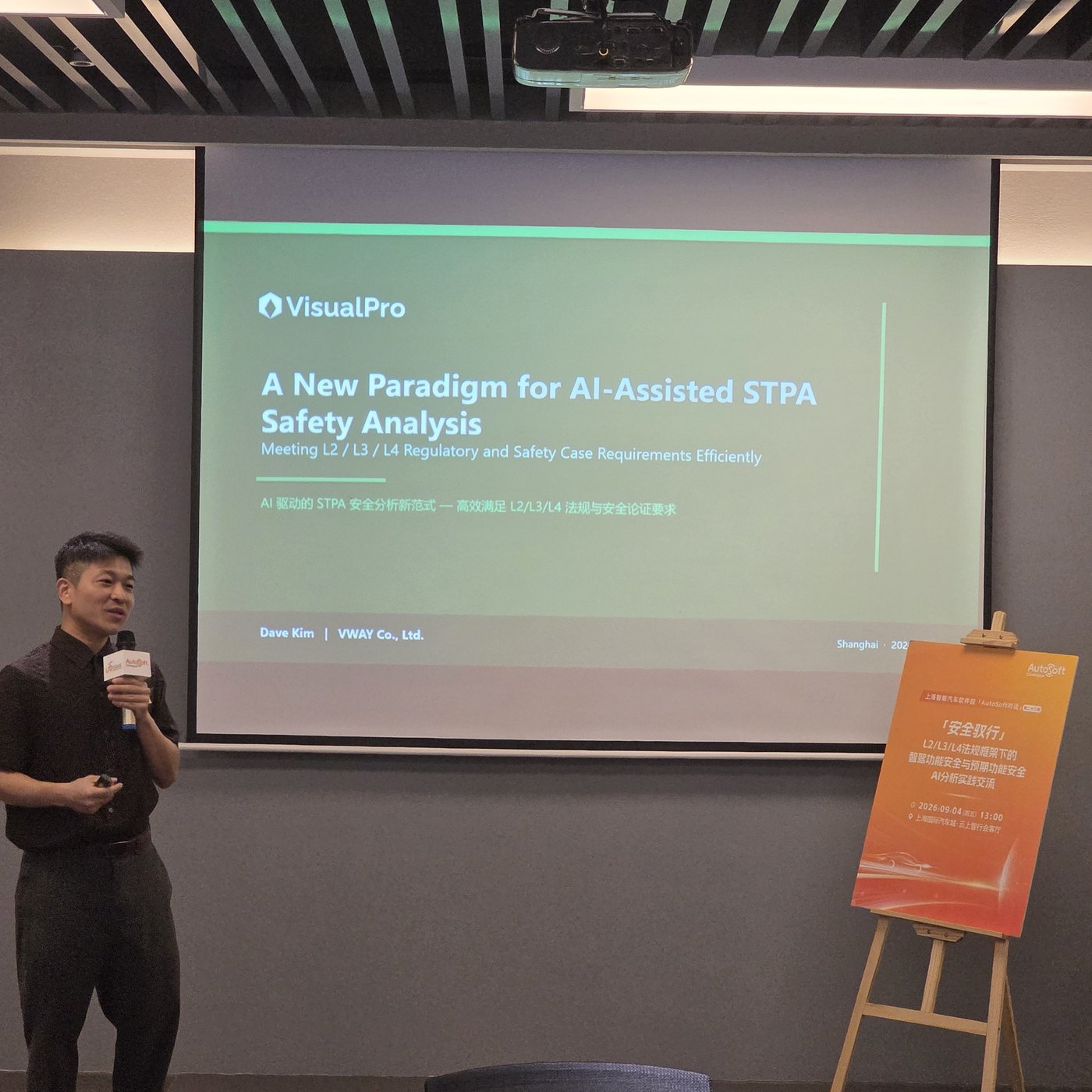 VWAY speaker with microphone at the opening slide “A New Paradigm for AI-Assisted STPA Safety Analysis”