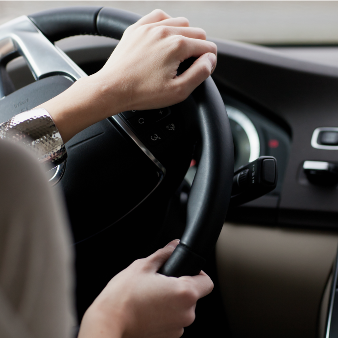 A driver's hands on a steering wheel — closing image of the Engine Stop-Start (ESS) STPA example